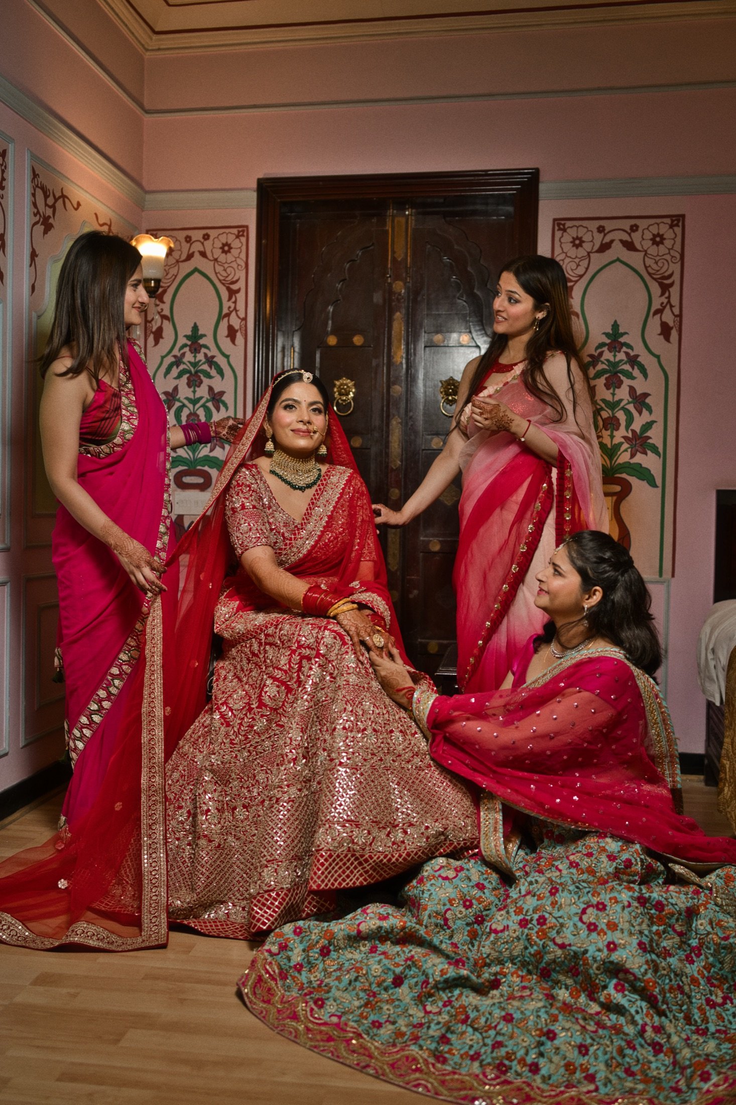 Bridal Portraits: Her people, close by. Hands on her shoulders, helping hands at her lehenga.