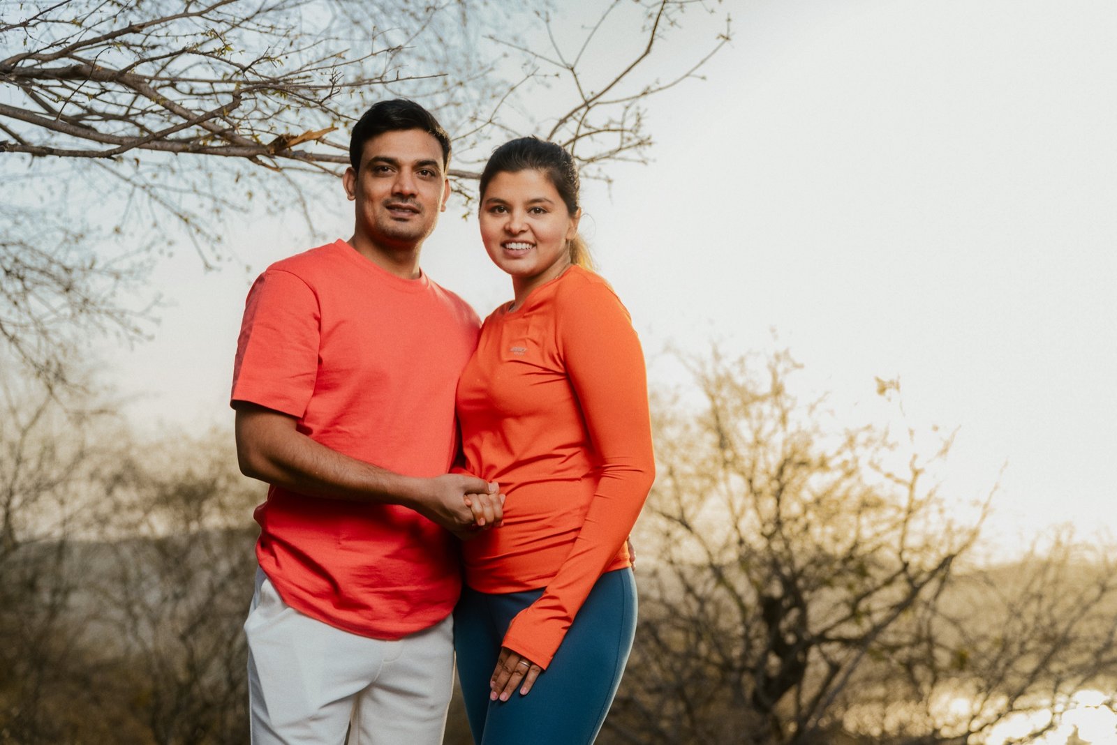 Wandering Together: Matching orange, matching smiles. A long road, unhurried.