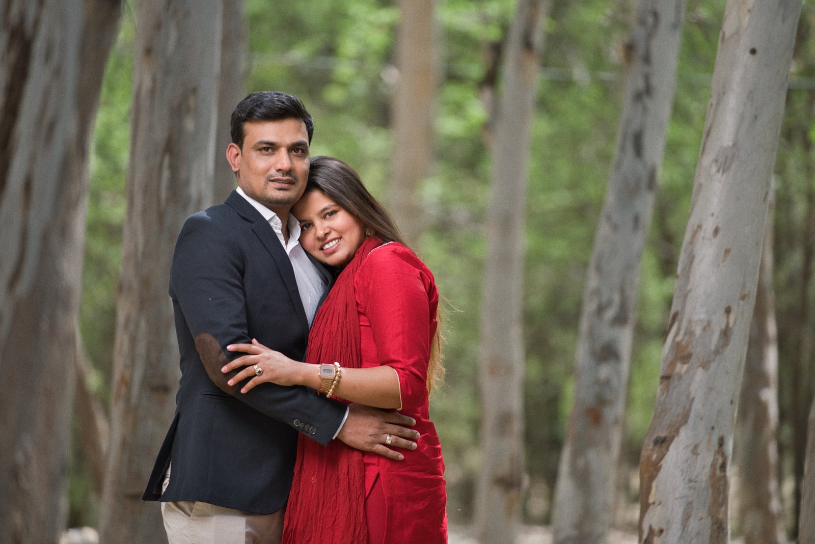 In Each Other’s Arms: A slow dance in green light. Held close between the trunks.